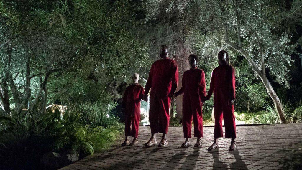 family of 4 standing in a darkened street