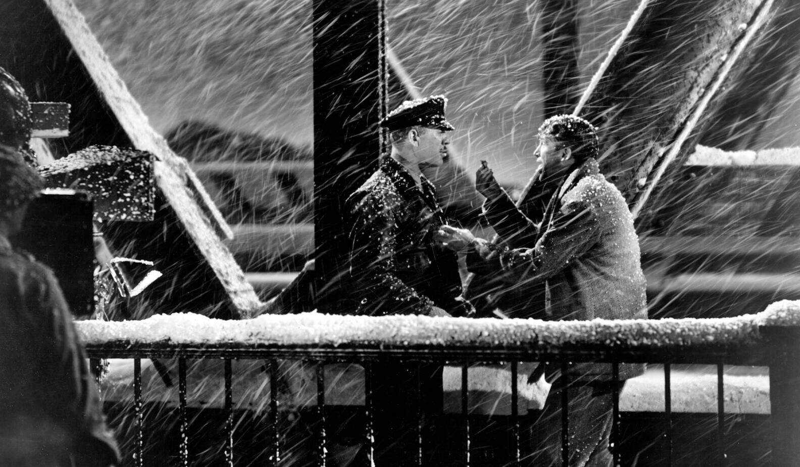 two men on a snowy bridge