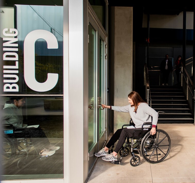 Students try to navigate the campus in wheelchairs to understand the need for ADA compliance