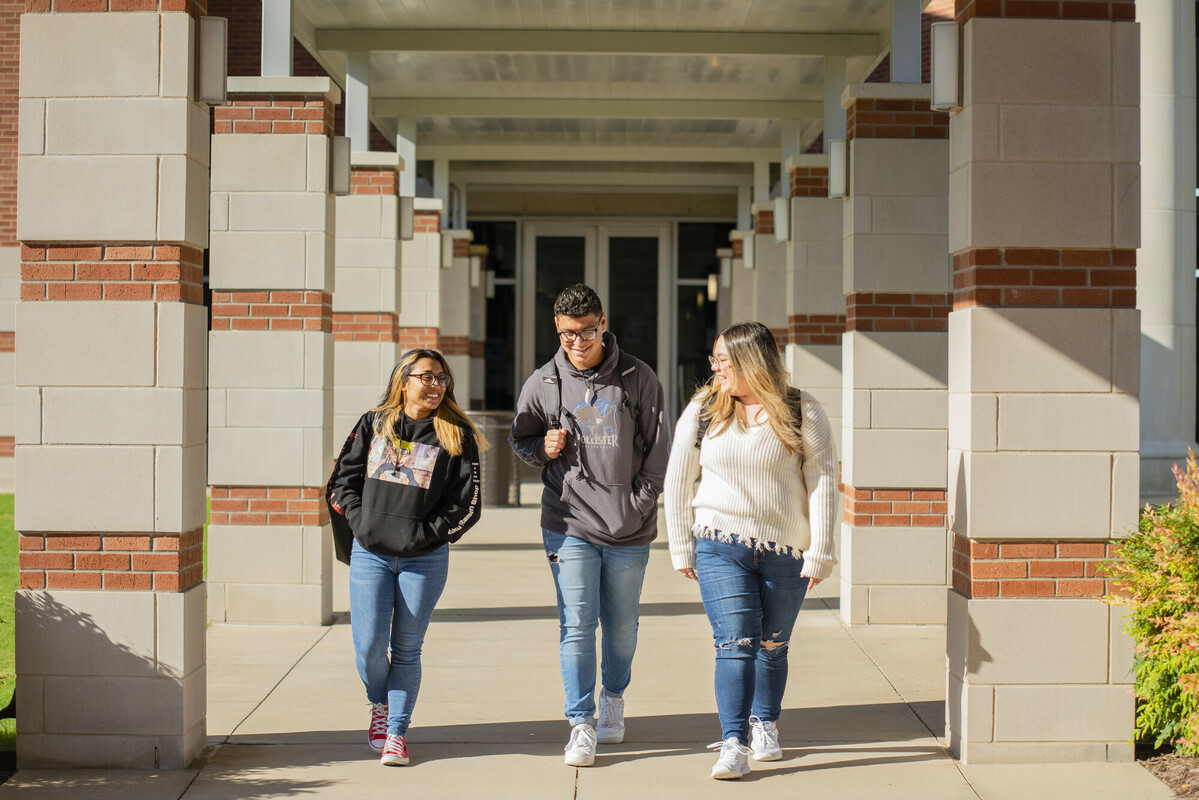 Three students walking outside a Collin College campus