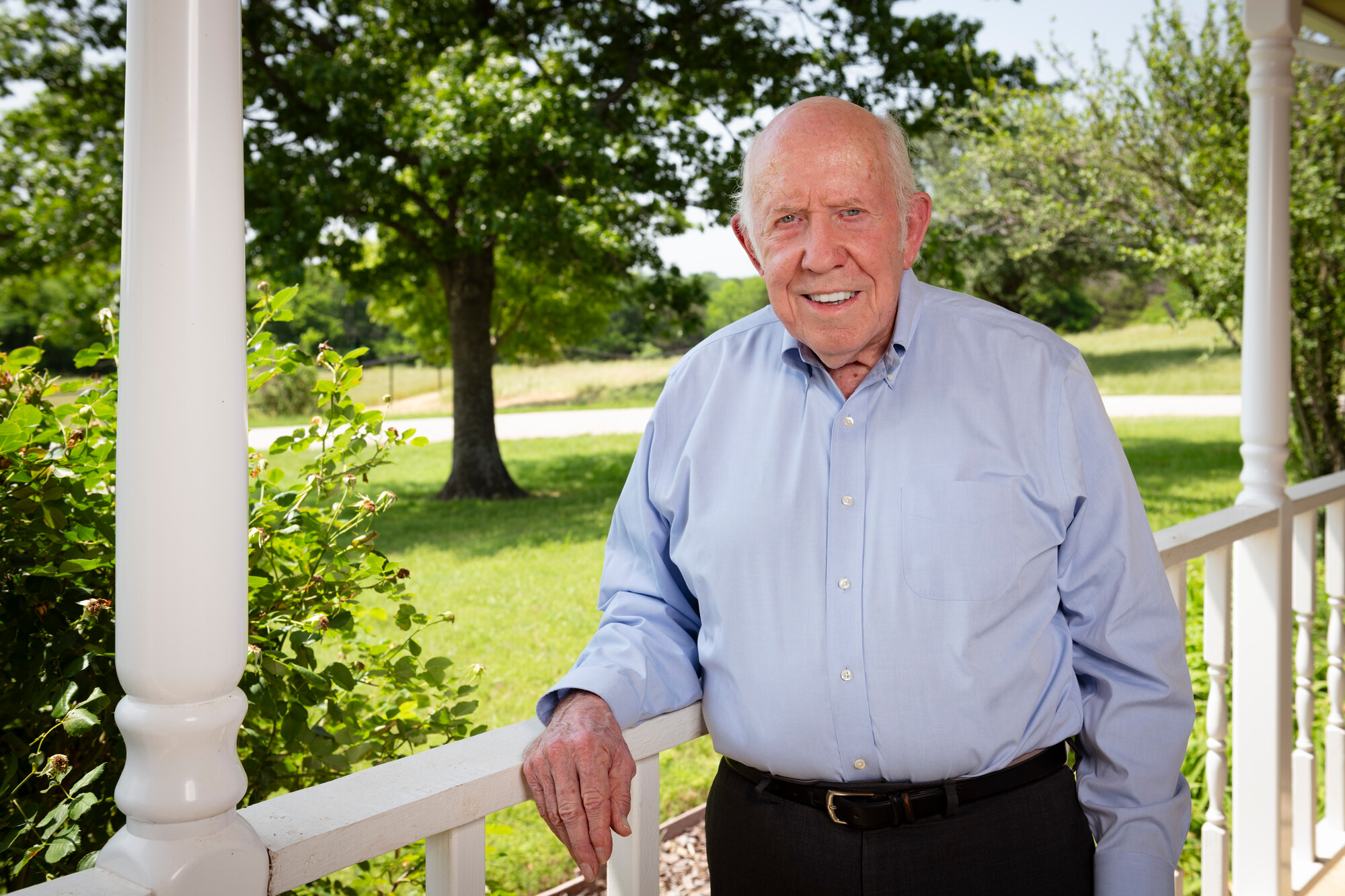 Bob Collins poses on front porch of residence 