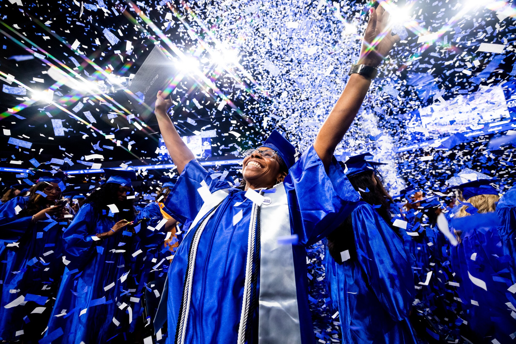 graduate student in regalia, smiling 