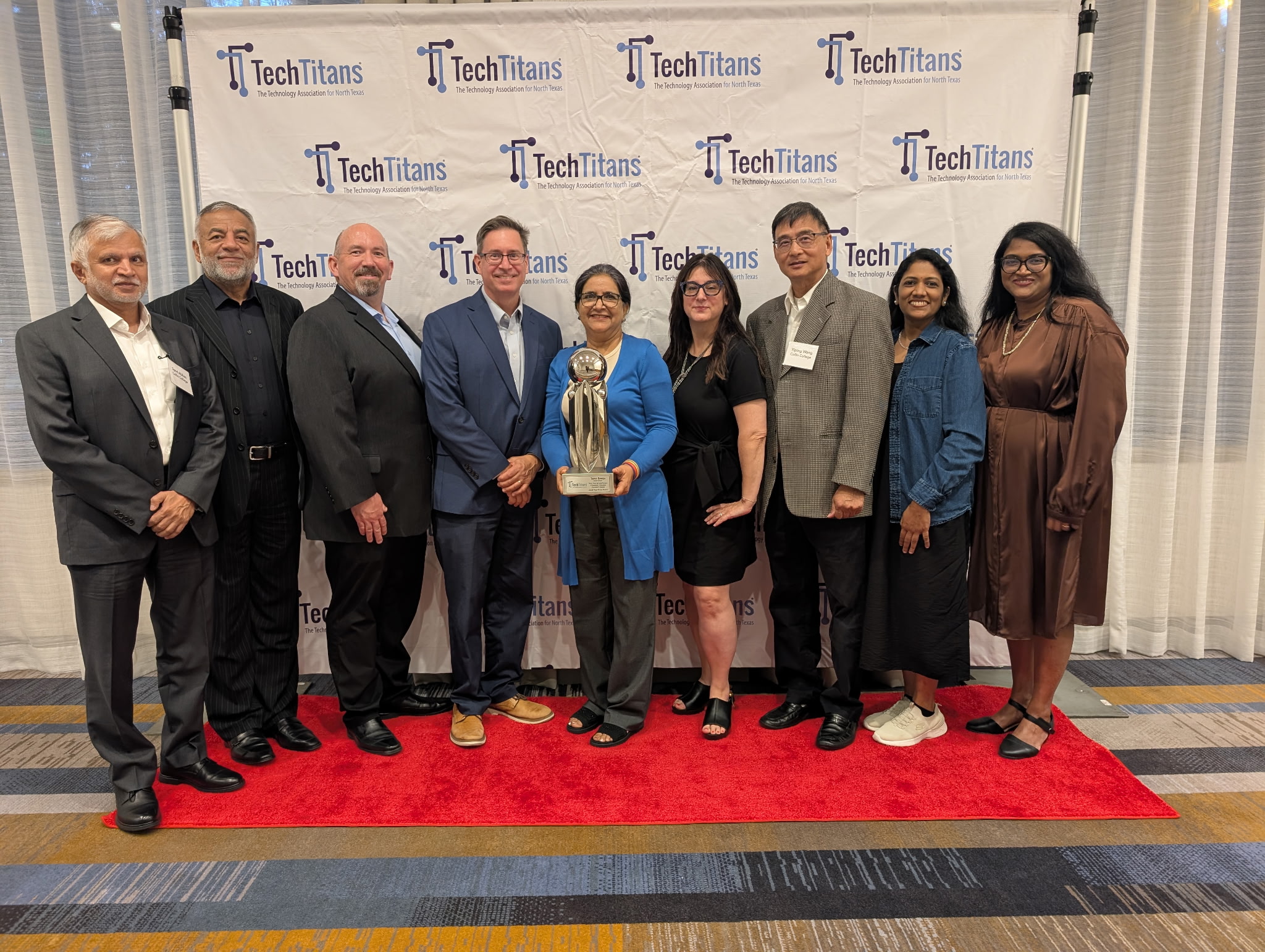 Group picture of nine people posing with award.