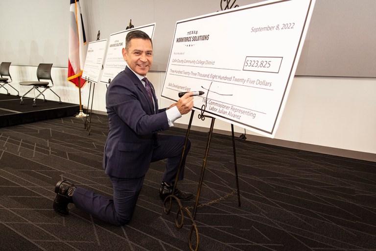 Texas Workforce Commission Skills Development Fund Grant Check Signing. Signing Checks - Julian Alvarez, Commissioner Representing Labor, Texas Workforce Commission. Photo by Nick Young, Collin College photographer