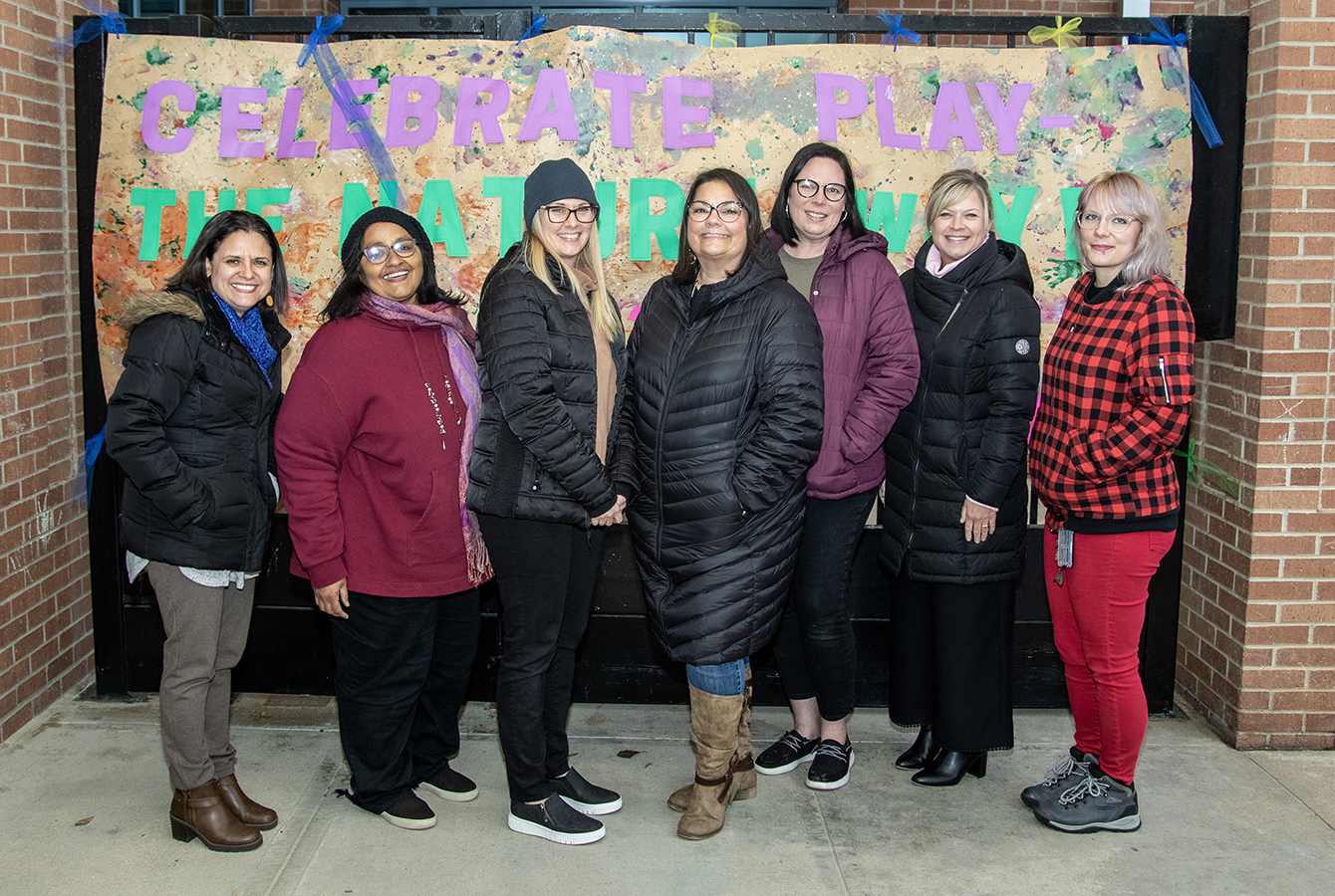 Collin College faculty and staff at the Child Development Lab School playground ribbon cutting